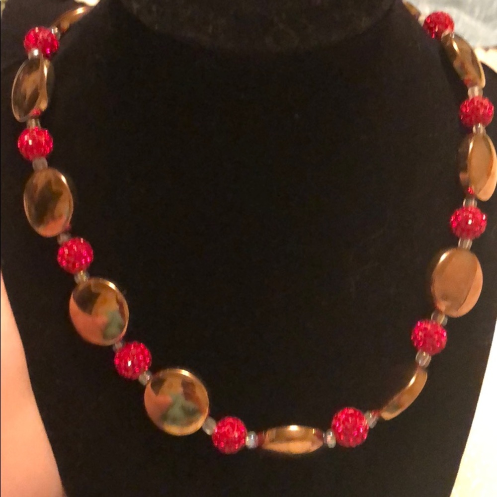 Gold and red necklace.